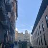 In this picture, school just got out and lots of kids and parents are walking around! The road on the right is where bulls run out from during the Running of the Bulls Festival, and to the left are old apartment buildings. See how narrow the streets are!