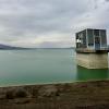 An abandoned building from the Soviet era that is connected to a dam