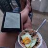 Dinner time! Reading a book on my porch with a bowl of rice, veggies, and fried eggs