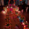 The Fulbright ofrenda lit with candles