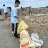 Trash and recyclables are sorted and put into separate bags to be carried off the beach