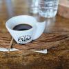 Famous Cuban coffee served on a tobacco leaf with a stick to stir the sugar in