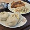 Donkkaseu (돈까스), a breaded pork cutlet covered in a rich, curry-like sauce and served with cabbage salad and rice