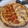 At a pizza restaurant, I ordered a half-and-half pizza; one side was pepperoni, and the other was bacon potato! It had all the usual toppings like cheese and tomato sauce, plus extras like potato wedges, bacon, onions, sweet corn, and mayonnaise.