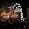 A nighttime procession through the streets, with the cross, Jesus, and Mary carried alongside a live band