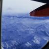 View of the Swiss Alps outside the airplane window on the way to Rome