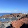 El Golfo - cliffs of volcanic rock alongside the ocean and black sand create a breathtaking, dramatic colored landscape