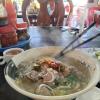A steaming hot bowl of a Cambodian soup called "Kuy Teuv"