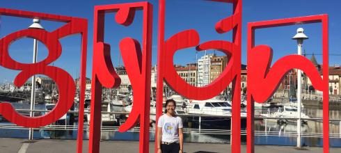 Me standing next to the city sign of the coastal city of Gijón