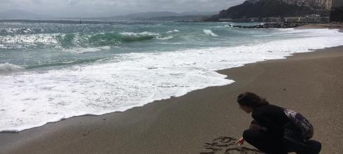 Writing "Ceuta 2019" in the sand