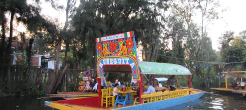 Riding a trajinera (boat) through Xochimilco is a colorful way to experience local culture