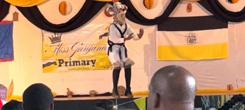 A student doing a dance called "Jonkunu" where the drummers are supposed to beat to his footsteps