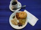 A meal including piñones, a sopaipilla, and wheat coffee