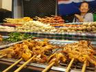 A street vendor, selling skewered meats