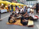 A group of children playing instruments in a market