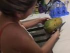 My host sister cutting the papaya for dessert for the whole family