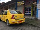 A taxi in La Maná Canton, Cotopaxi Province in front of a store