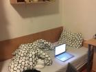 A picture of my bed in my dorm room-- it is a twin bed with a comforter!