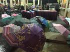 Students find shelter from the rain in a cafe as umbrellas dry outside
