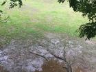 Muddy puddles pool outside the hostel after a rainstorm