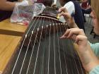 Up close on a smaller version of the guzheng