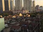 Run-down slums that sit behind average apartment buildings
