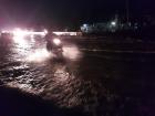 This is not a river, but a flooded street with a motor-biker riding on through