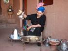 Local woman offering tea outside of her home 