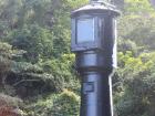 The black side of the lighthouse that a ship would use to steer away from the island at night