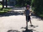 Aiden riding on a scooter, which is a popular way to get around in Paris 