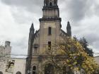 A beautiful local church with the yellow trumpet tree decorating the front. 
