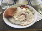 A sweet Bangalore bun (left), a dosai (lower right), and chutneys (upper right) make for a delicious breakfast