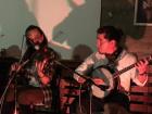 The fiddler and banjo player are jamming to an Irish tune