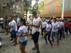 Parade performers sporting t-shirts with an "I love Saint Francis" logo