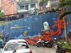One of the oldest murals in Comuna 13, a toad and a mermaid in a fantasy land