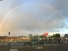 Beautiful rainbow at the bus stop. Notice all of the signs!