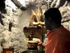 Here a Hindu priest is performing aarti to Shiva