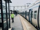 A caretaker sweeping up loose trash on the platform