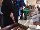 My principal and her grandson cut the vasilopita at her father's cafe