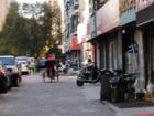 A peaceful street slowly being absorbed by the parking issue 
