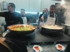Meat is pushed to the sides and vegetables are added to the center to allow the vegetables to cook faster