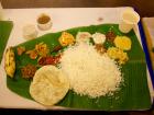 Sadhya is served on a banana leaf.