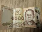 The front of a 1000 baht bill