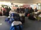 All of the tourists and their things waiting for their flights back to Kathmandu