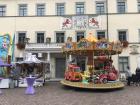 A merry-go-round in front of city hall 