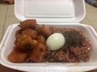 This is waakye, or rice and beans. It is grayish purple in color and very thick. On top of it is a shito sauce that gives the rice and beans a kick!