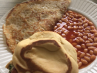 This is one variation of a breakfast that is eaten in Ghana. A roll, beans, eggs, and juice gets the day started. 