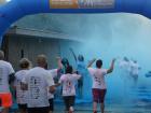 Volunteers throwing colored powder at the runners
