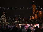 The Christmas market is decorated in lights and filled with wooden toys