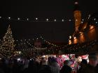 The Christmas market is decorated in lights and filled with wooden toys